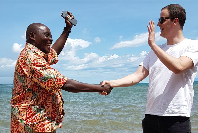 Two men joyously shaking hands